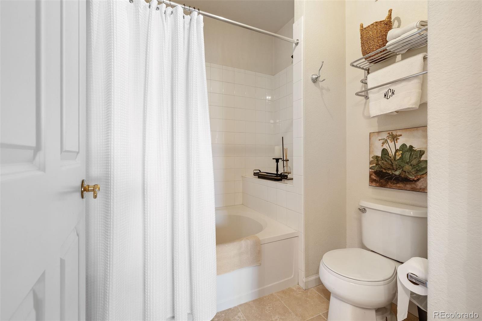 4035 South Dillon Way, Unit 204 Aurora, CO 80014 - Photo 16 of 24 a white toilet sitting next to a bathroom sink and tub
