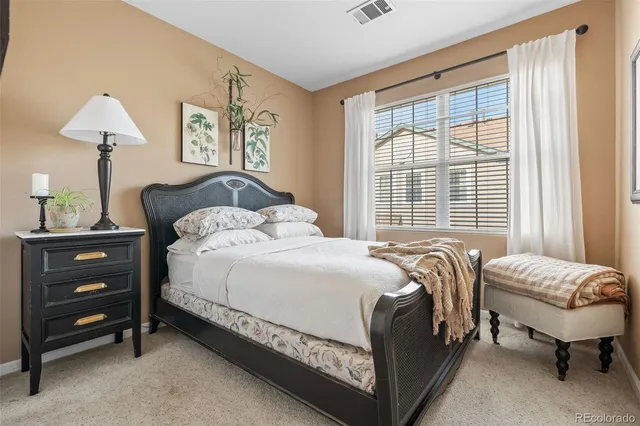 a bedroom with a bed and a lamp