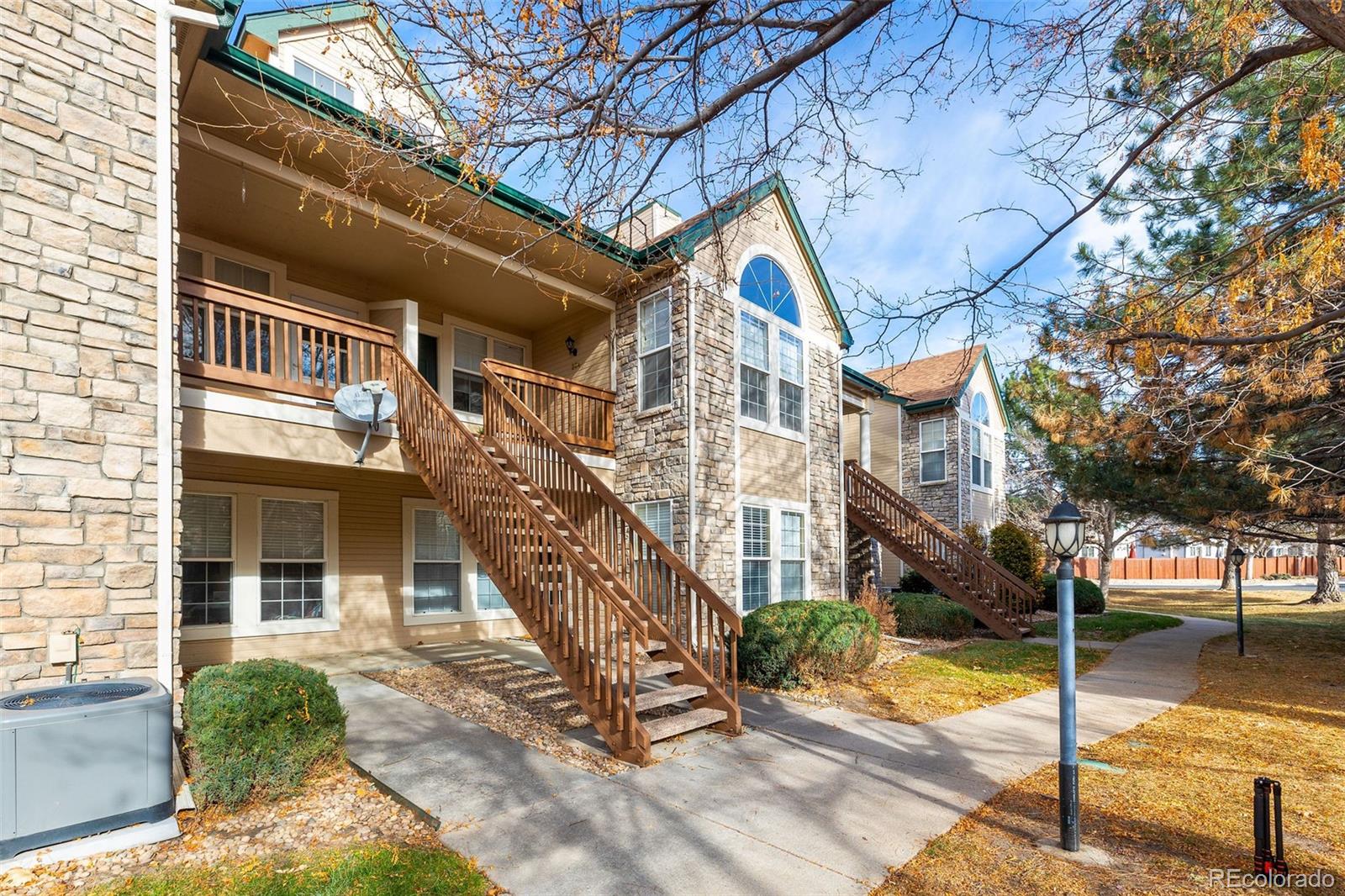 4035 South Dillon Way, Unit 204 Aurora, CO 80014 - Photo 2 of 24 a view of a building with a tree