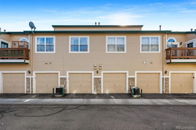 a front view of a house with a road