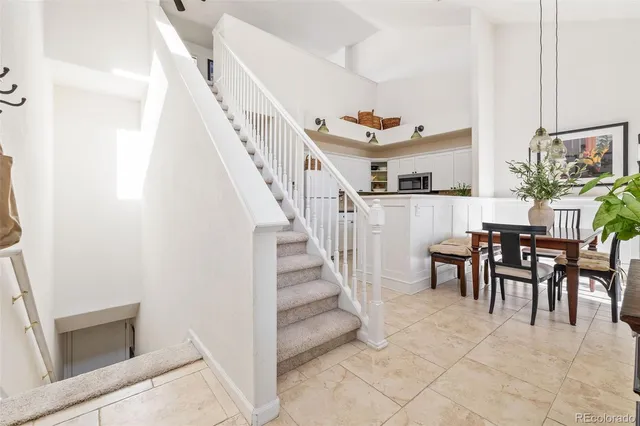 a view of a livingroom with furniture and stairs
