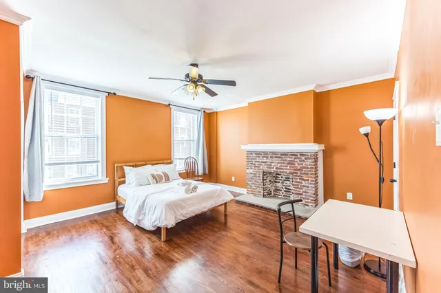 a bedroom with a bed and a table with chair