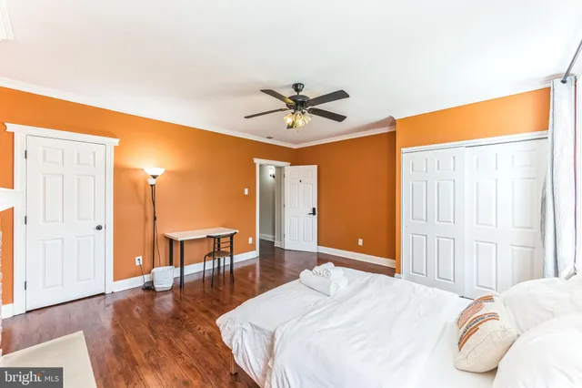 a bedroom with a bed and wooden floor