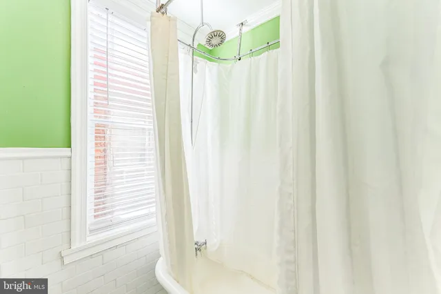 a bathroom with a mirror and a shower curtain