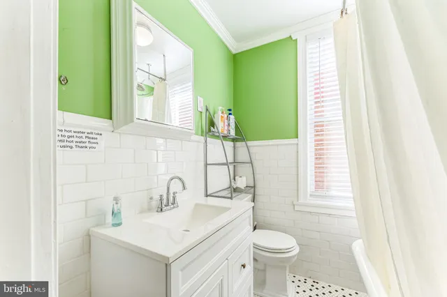 a bathroom with a sink toilet and mirror