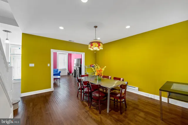 a dining room with furniture and wooden floor