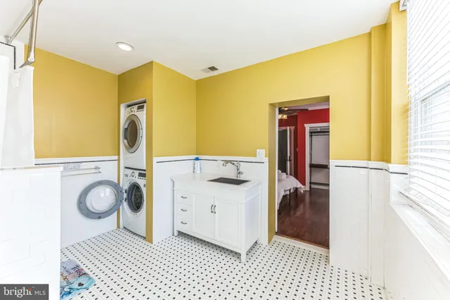 a bathroom with a sink a toilet and a window