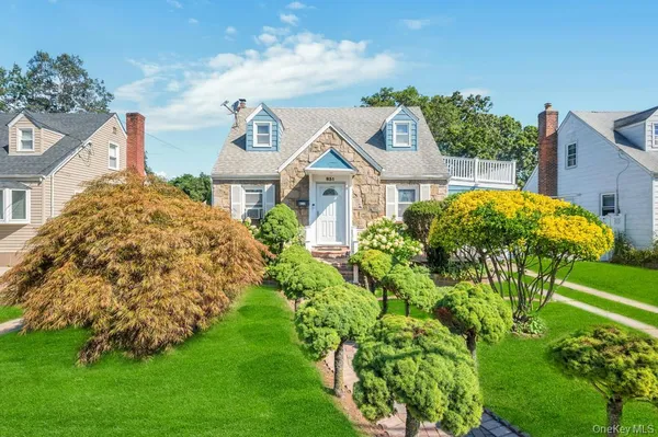 a front view of a house with garden