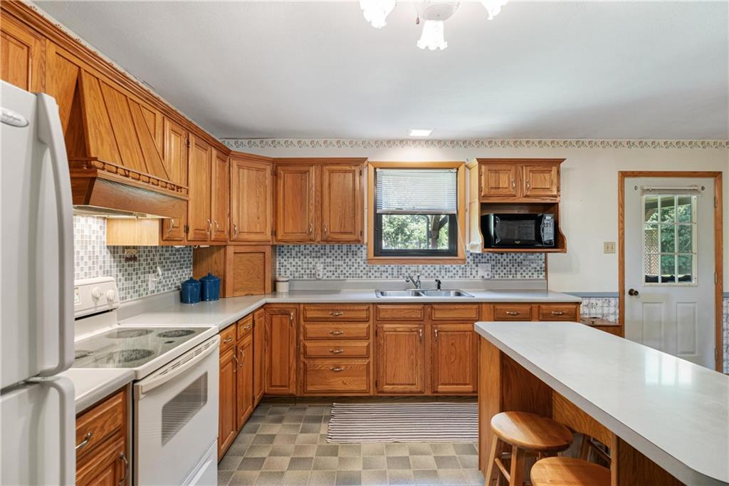 285 Rochester Road Freedom, PA 15042 - Photo 24 of 46 a kitchen with stainless steel appliances granite countertop a sink stove and cabinets