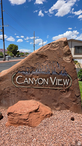 1450 North Dixie Downs Road, Unit 51 St. George, UT 84770 - Photo 12 of 25 Red rock landscape sign with "Canyon View" engraving and a decorative rock border