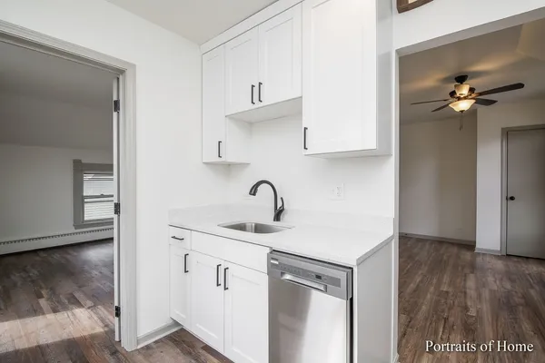 a kitchen with a sink cabinets and appliances