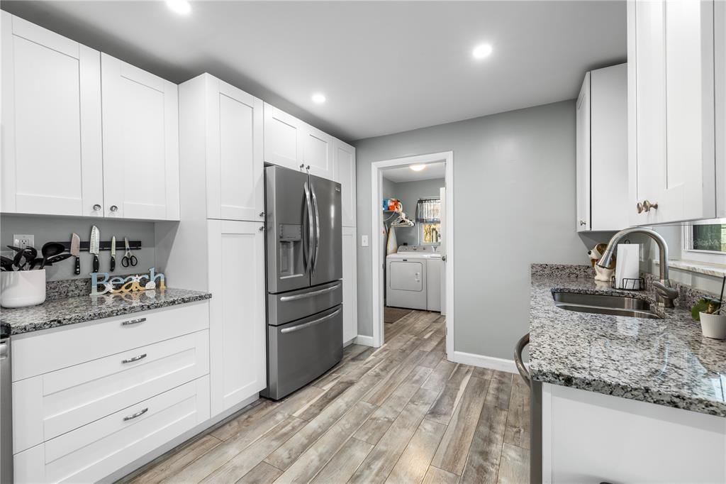 11781 68th Avenue Seminole, FL 33772 - Photo 19 of 60 a kitchen with granite countertop a refrigerator and a sink