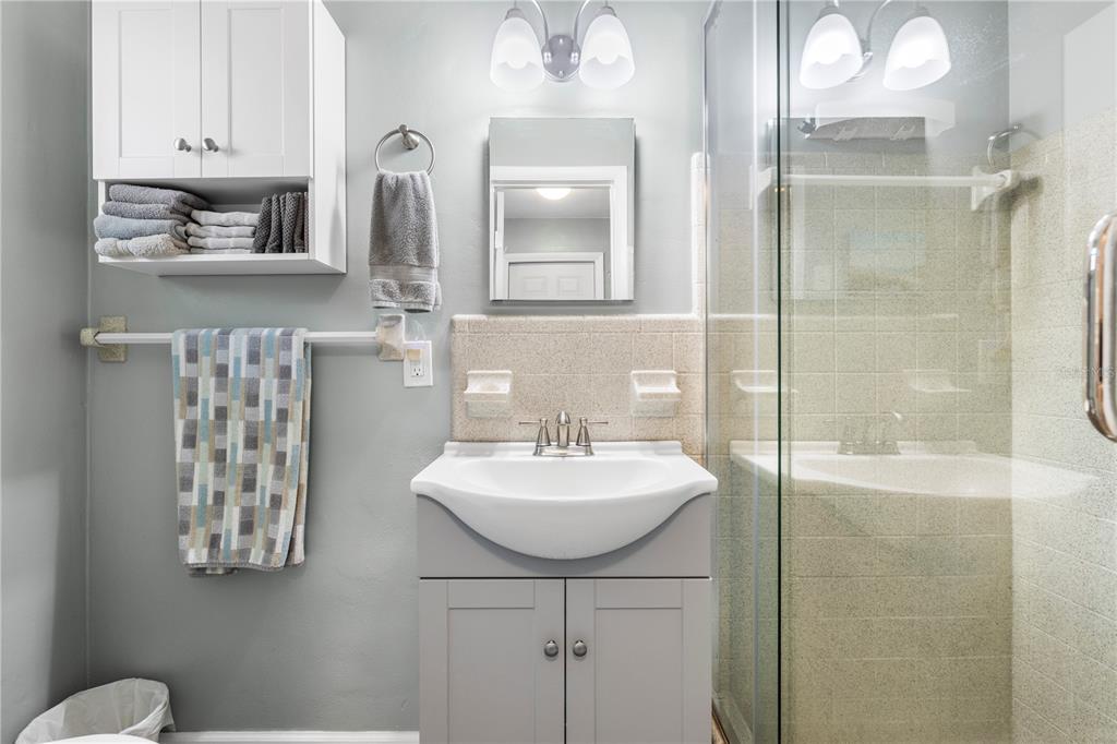 11781 68th Avenue Seminole, FL 33772 - Photo 21 of 60 a bathroom with double vanity sinks and a mirror