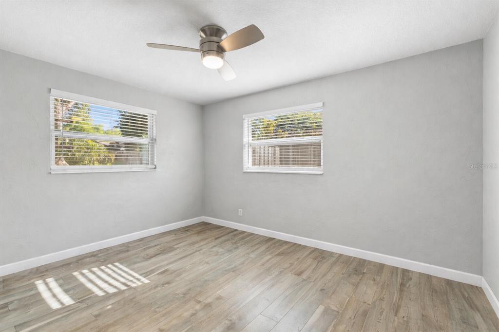 11781 68th Avenue Seminole, FL 33772 - Photo 24 of 60 a view of an empty room with wooden floor and a window