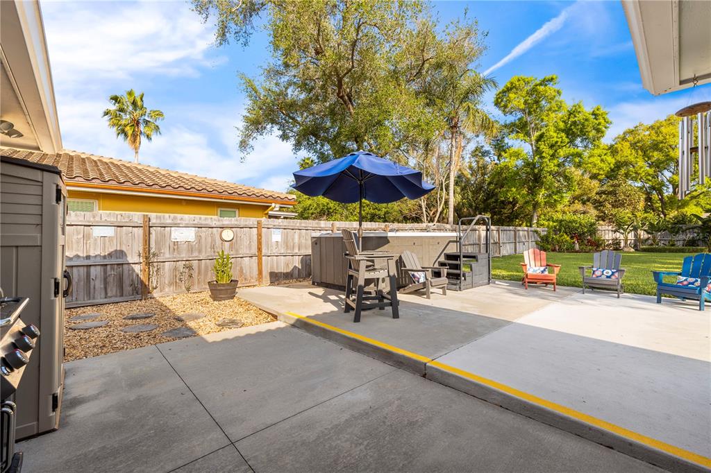 11781 68th Avenue Seminole, FL 33772 - Photo 29 of 60 a view of a patio with a table and chairs under an umbrella