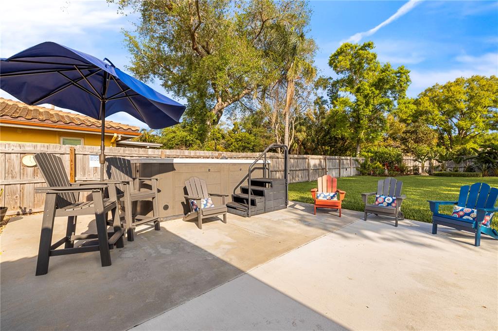 11781 68th Avenue Seminole, FL 33772 - Photo 31 of 60 a view of a patio with table and chairs under an umbrella