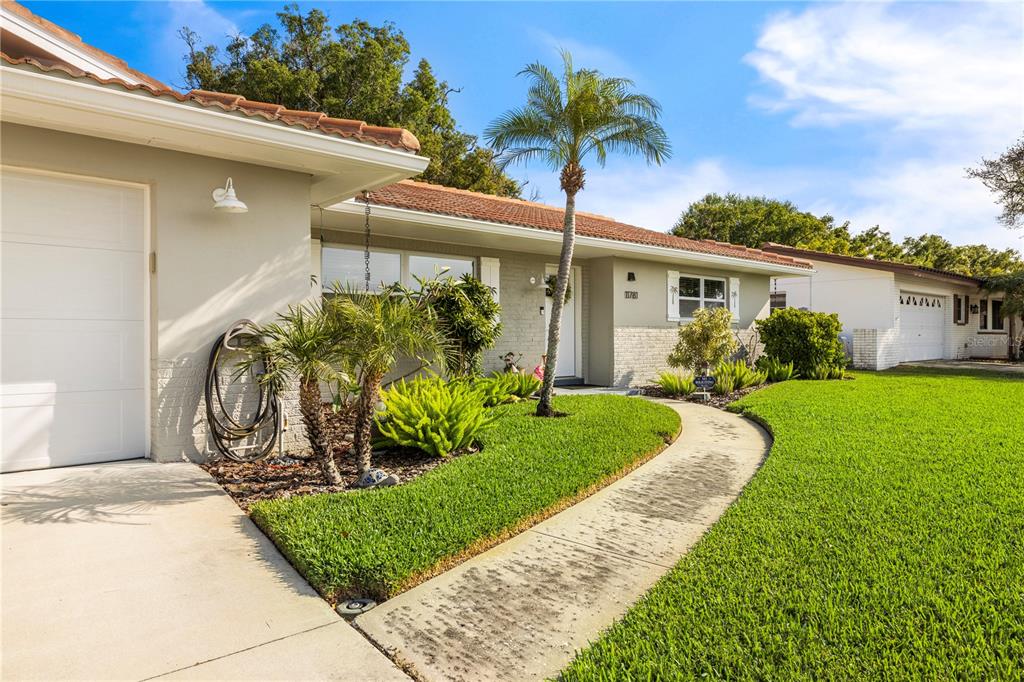 11781 68th Avenue Seminole, FL 33772 - Photo 42 of 60 a front view of a house with garden