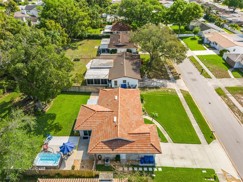 11781 68th Avenue Seminole, FL 33772 - Photo 58 of 60 an aerial view of a house with a garden and trees
