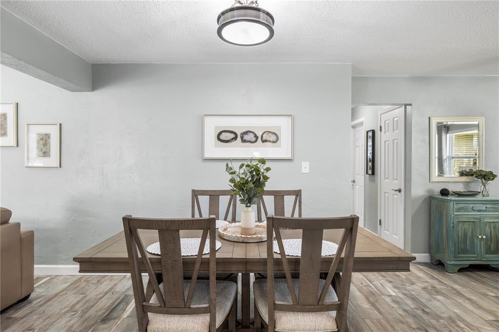 11781 68th Avenue Seminole, FL 33772 - Photo 9 of 60 a view of a dining room with furniture and wooden floor