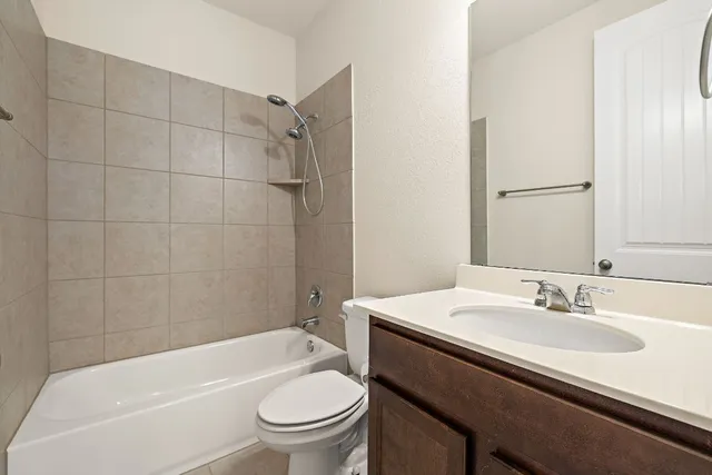 a bathroom with a sink a toilet and bathtub