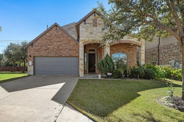 a front view of a house with a garden