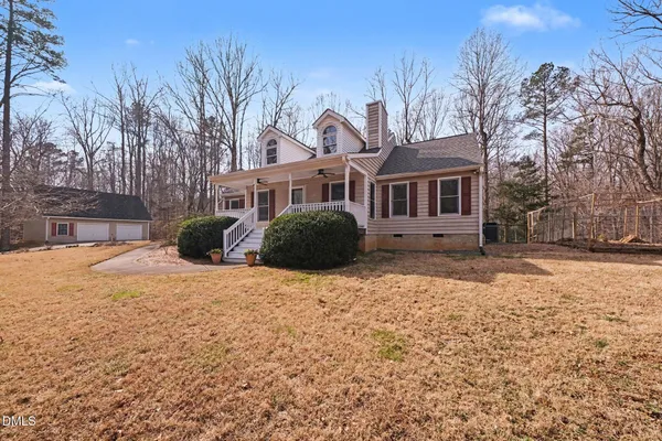 a front view of a house with a yard covered in snow