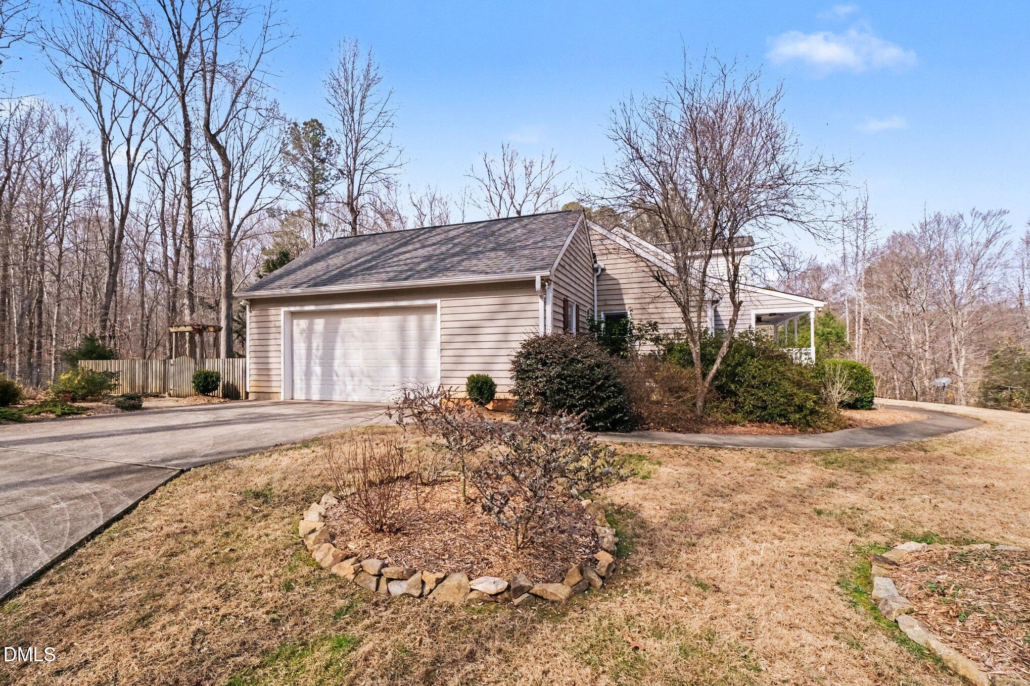 2404 Bane Road Efland, NC 27243 - Photo 9 of 46 a front view of a house with a yard and garage