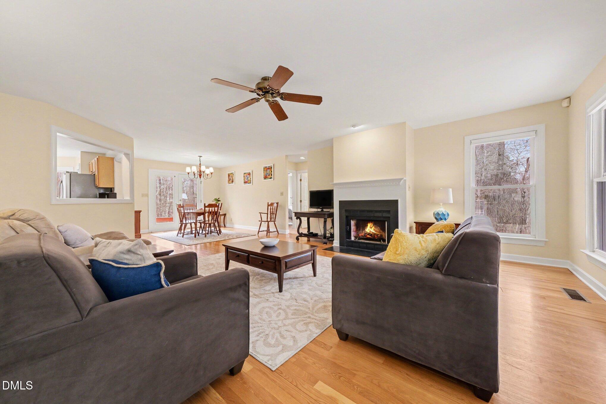 2404 Bane Road Efland, NC 27243 - Photo 10 of 46 a living room with furniture a fireplace with wooden floor