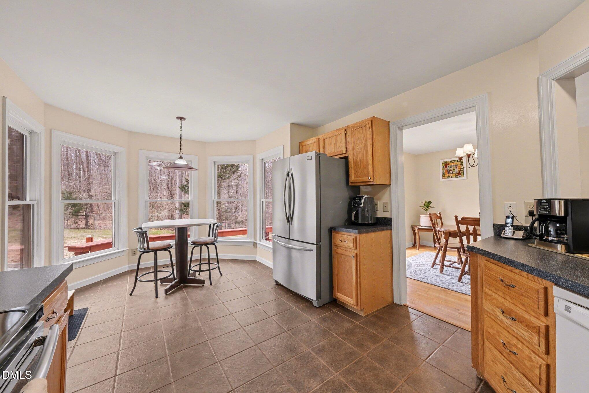 2404 Bane Road Efland, NC 27243 - Photo 13 of 46 a kitchen with a refrigerator and furniture