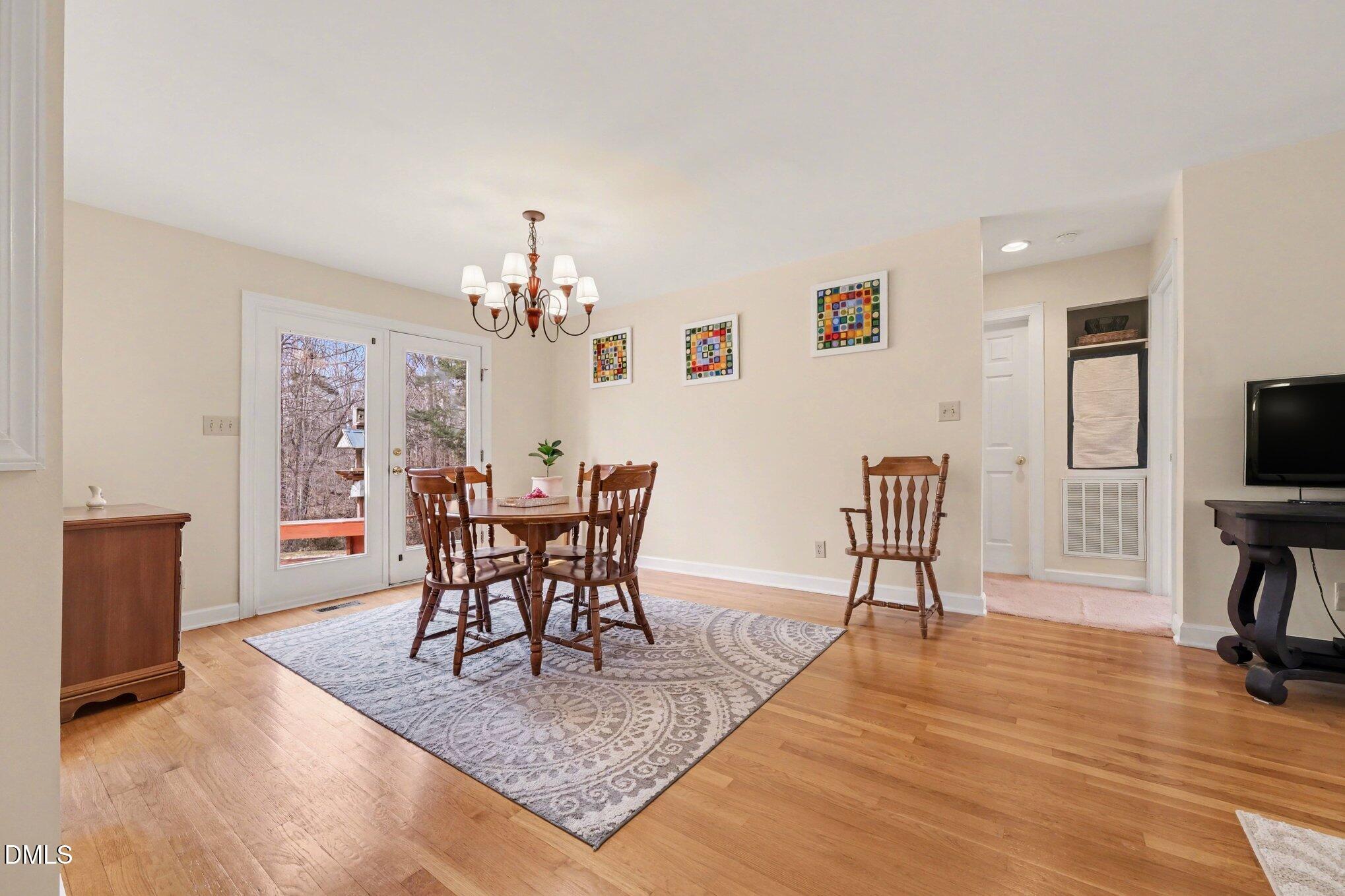 2404 Bane Road Efland, NC 27243 - Photo 17 of 46 a view of a dining room with furniture and wooden floor