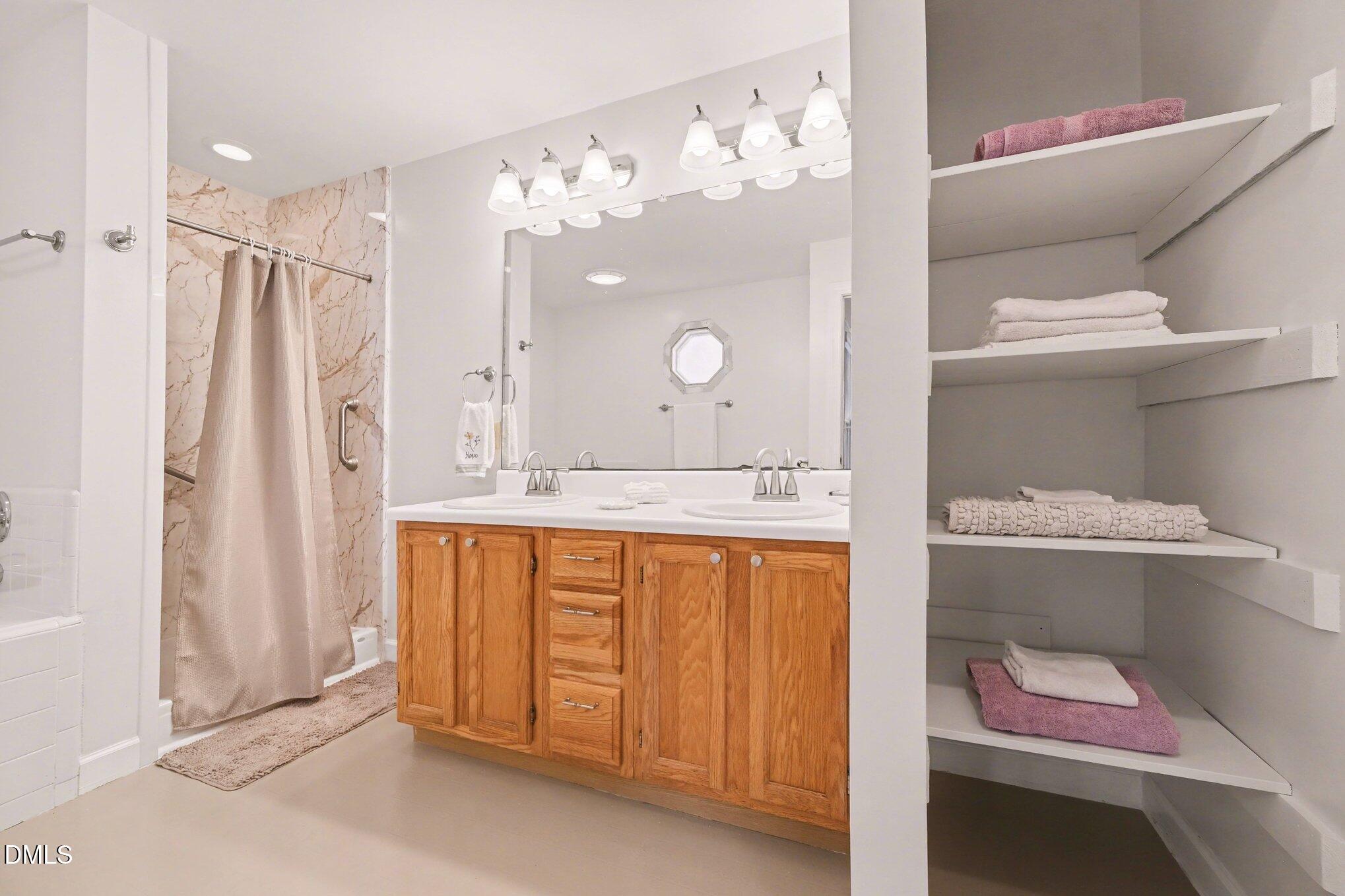 2404 Bane Road Efland, NC 27243 - Photo 21 of 46 a bathroom with a sink a vanity and a mirror