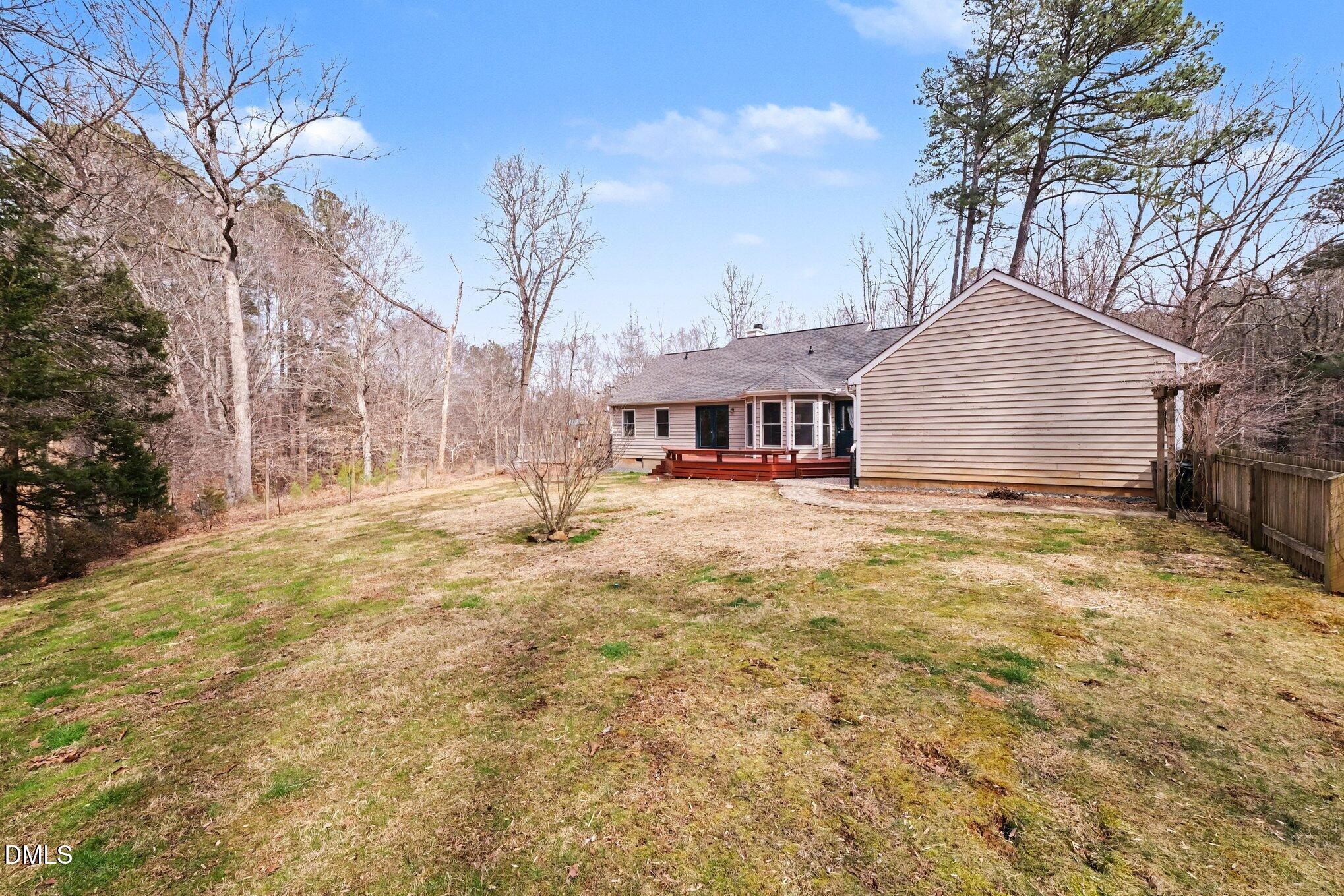 2404 Bane Road Efland, NC 27243 - Photo 2 of 46 a front view of a house with a yard and large trees