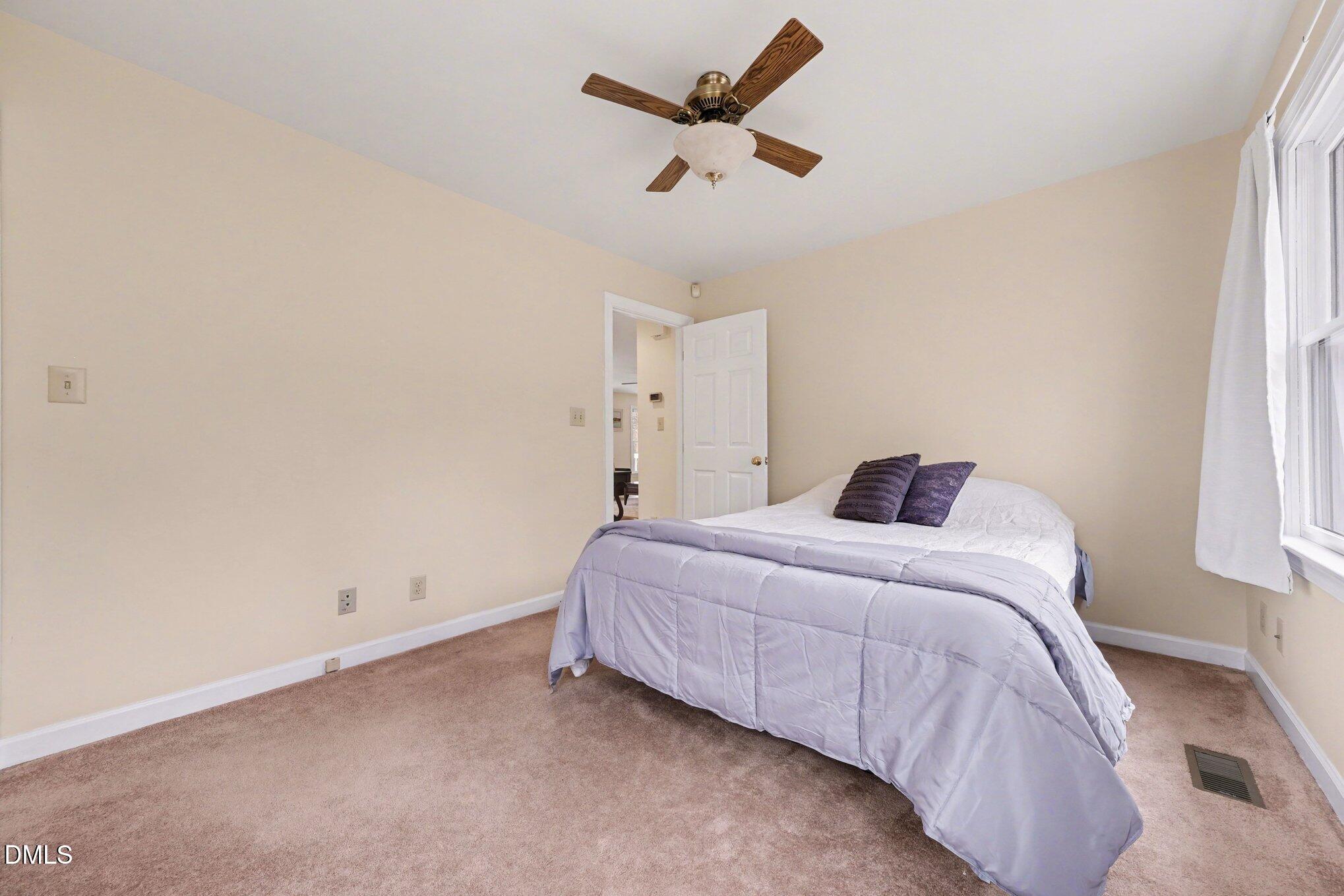 2404 Bane Road Efland, NC 27243 - Photo 27 of 46 a bedroom with a bed and a window