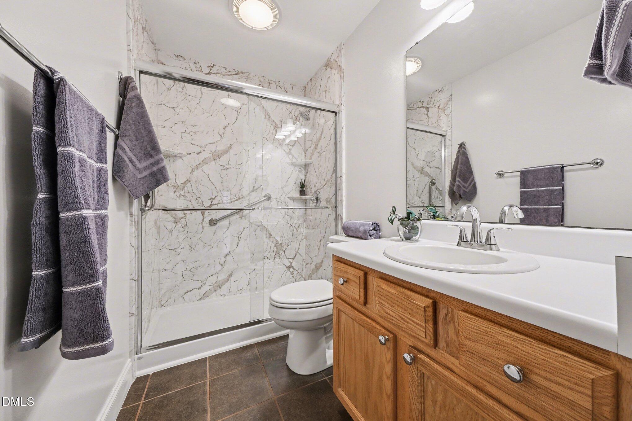 2404 Bane Road Efland, NC 27243 - Photo 28 of 46 a bathroom with a sink a toilet and shower