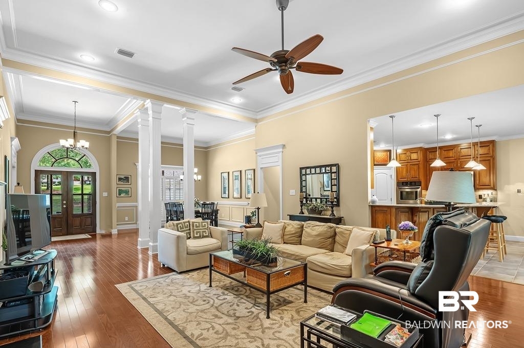 29976 Dolive Ridge Daphne, AL 36527 - Photo 19 of 58 Living room featuring ornate columns, crown molding, and light wood-type flooring