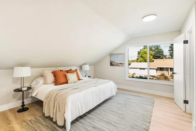 a living room with a bed furniture and a window