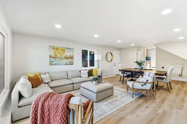 a living room with furniture and painting on the wall