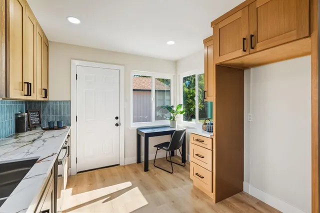 a view of entryway with dining room and wooden floor