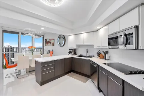 a dining room with furniture a chandelier and window