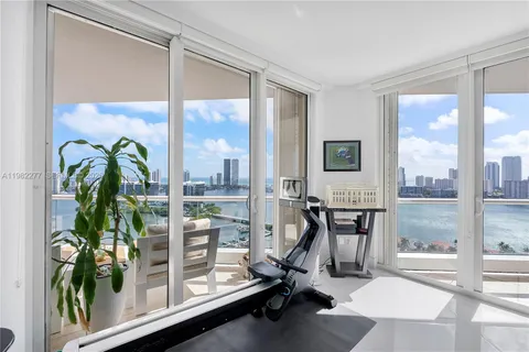 a living room with furniture fireplace and a large window