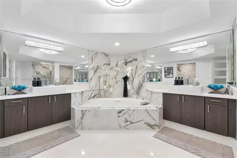 a bathroom with a sink vanity mirror and toilet