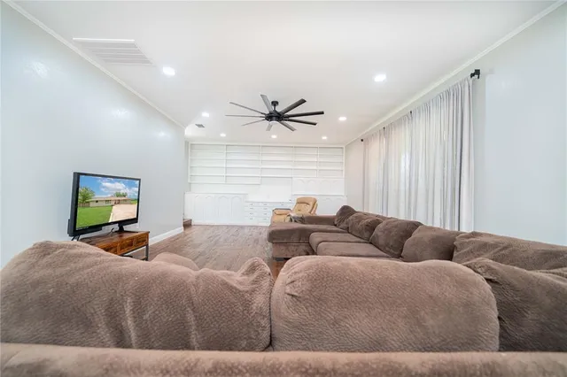 a living room with couches and a flat screen tv