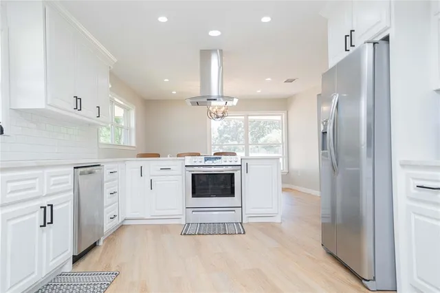 a view of a kitchen with electric appliances