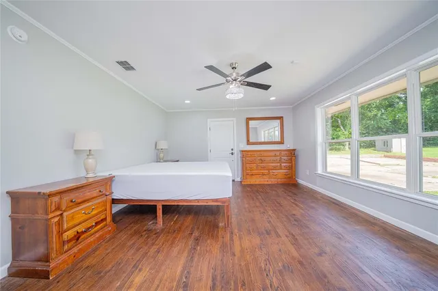 a spacious bedroom with a bed and a large window
