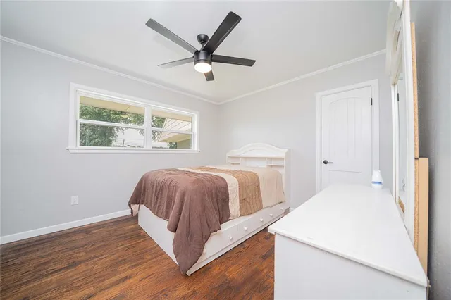 a bedroom with a large bed and a chandelier