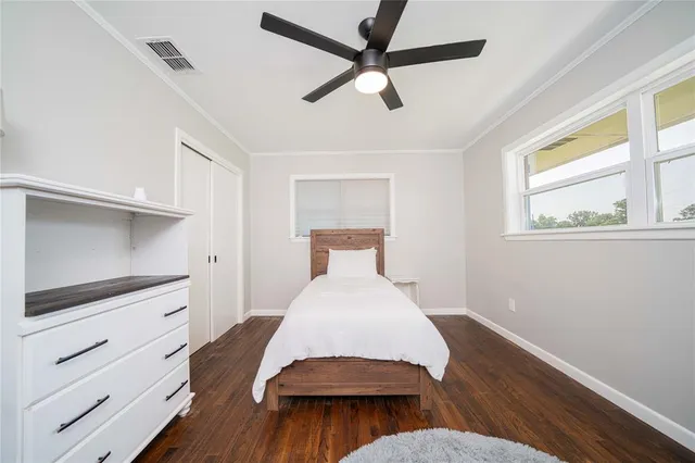 a hallway with closet and wooden floor