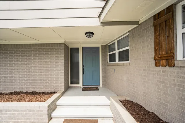a front view of a house with white walls