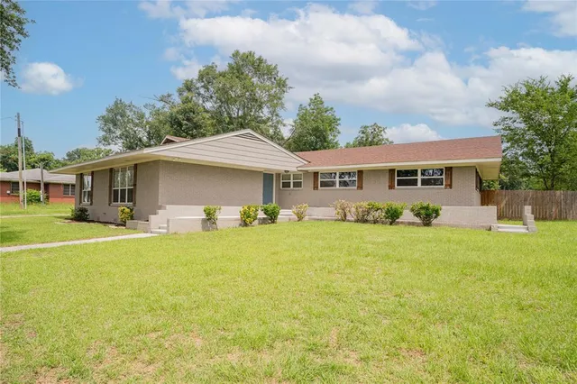 a front view of a house with a yard table and chairs