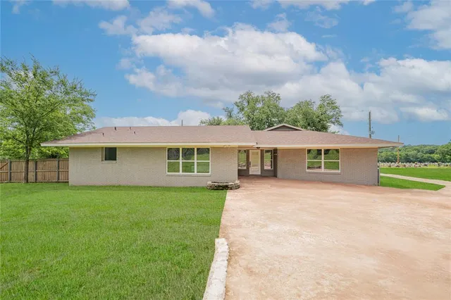 a front view of a house with yard