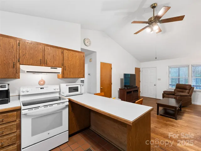 a kitchen with a cabinets and white appliances
